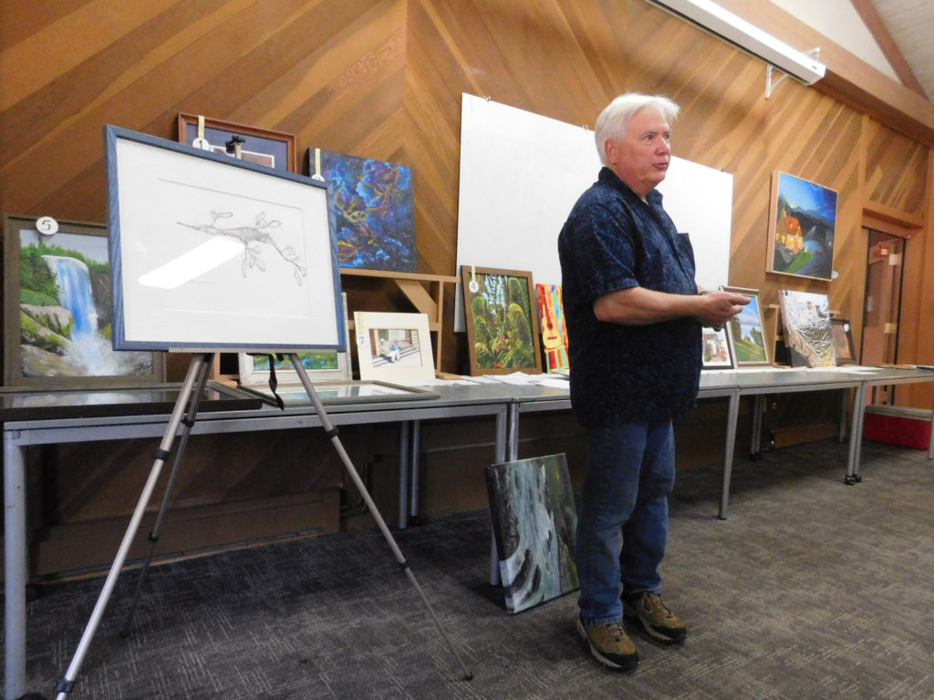 Artist Jeff Bramschreiber during a demonstration at the Campbell Artists' Guild on framing artworks