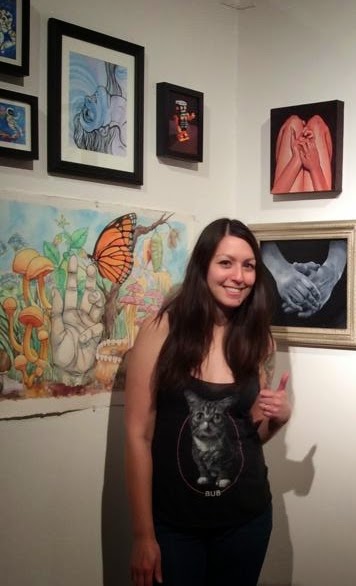Woman standing before her artwork